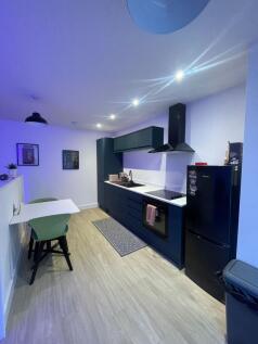 Contemporary fitted kitchen with dark cabinets,...
