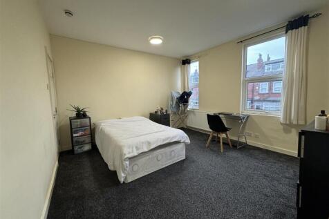 Bright and spacious living room with large wind...