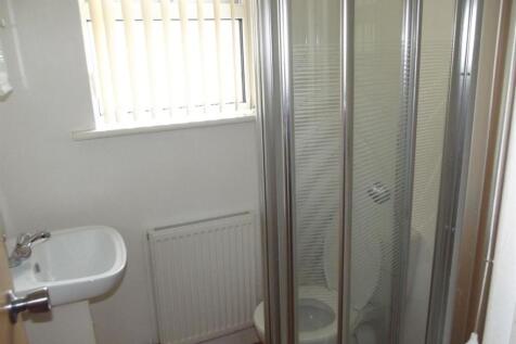 Compact and clean toilet room with a corner sin...