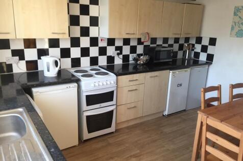Bright, practical kitchen with checkerboard til...