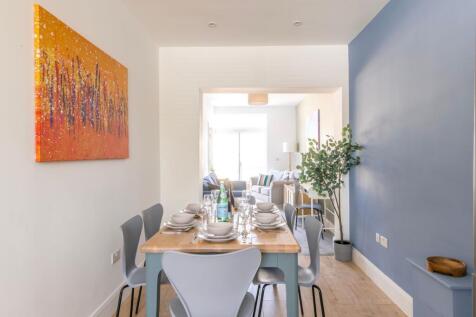 Bright open-plan dining area flowing into a cos...