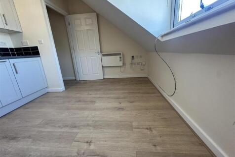 Bright living area with modern wood flooring...