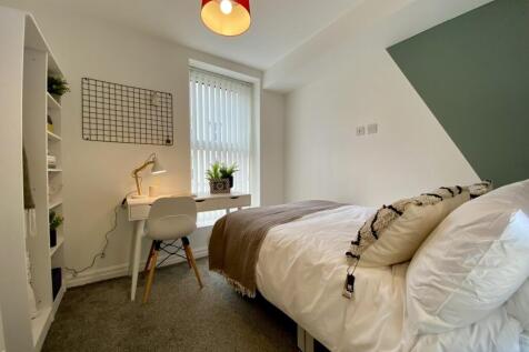 A bright and inviting double bedroom featuring ...