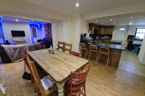 A spacious and modern living area with an open-...