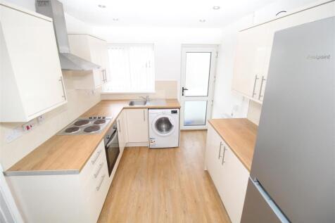 Bright modern kitchen with integrated appliance...