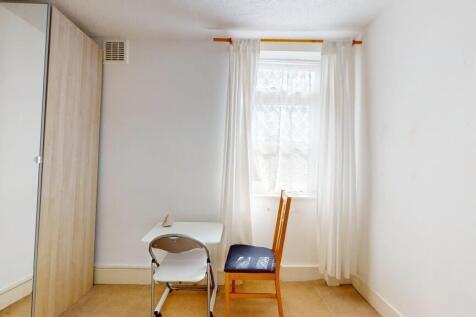 Bright study area with desk and ample storage...