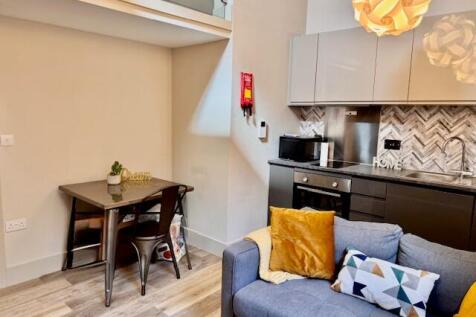 Bright, modern open-plan living area with a coz...