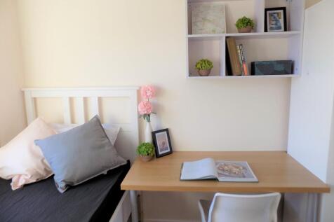 Bright, neatly styled bedroom with a simple whi...