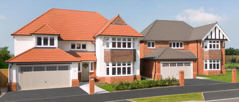 Modern detached houses with red and grey tiled roofs, white and brick exterior, and Driveways on a s