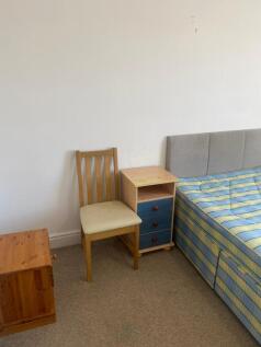 Simple furnished bedroom corner with a divan-st...