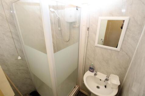 Bright bathroom with modern walk-in shower...