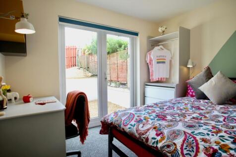 Bright, neatly styled double bedroom with large...