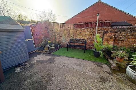 Sunny private courtyard with lawn and seating...