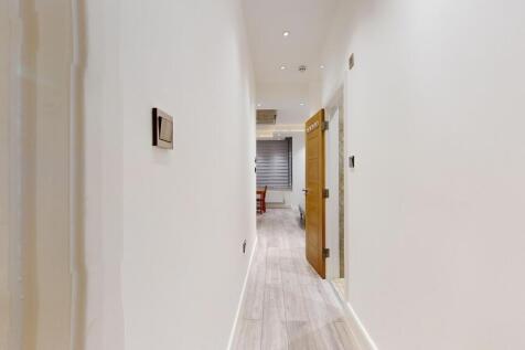 Bright, modern hallway with wood-effect floorin...