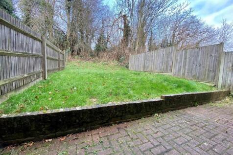 Private fenced garden with paved patio and lawn...
