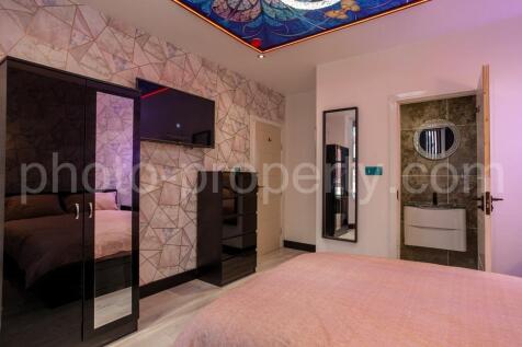Contemporary master bedroom with a comfortable ...