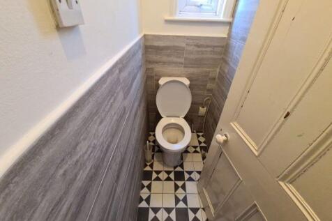 A clean and well-maintained compact toilet with...