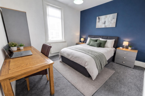 Contemporary bedroom with sapphire accents.png