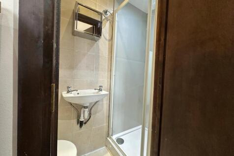 Modern tiled bathroom with a sleek shower cubic...