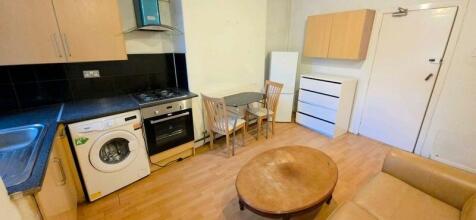 Bright kitchen with dining space and appliances...