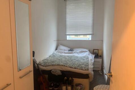 Bright bedroom with integrated storage and wind...