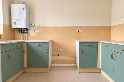 compact_sage_green_utility_kitchen_with_boiler.jpg