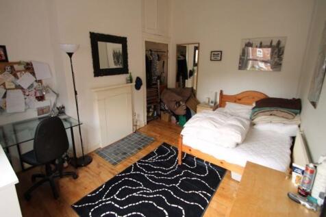 A spacious and inviting master bedroom featurin...