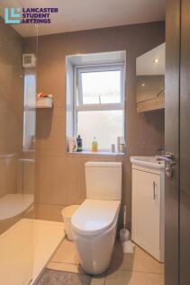 Modern bathroom with natural light and walk-in ...