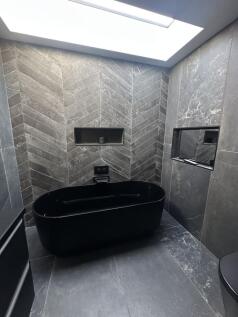 Bathroom showing built in television