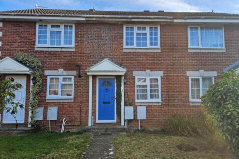 Red-brick terraced house with a bright blue fro...