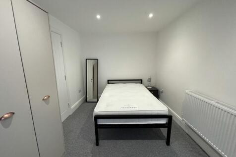 A bright and spacious double bedroom featuring ...