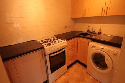Compact fitted kitchen with freestanding oven, ...