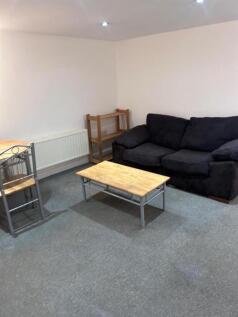 Cosy lounge with plush sofa and dining area...