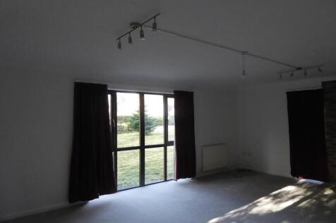 Spacious lounge with large floor-to-ceiling win...