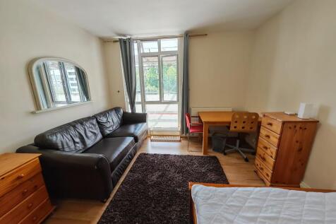 Spacious bedroom with dedicated desk and sofa...
