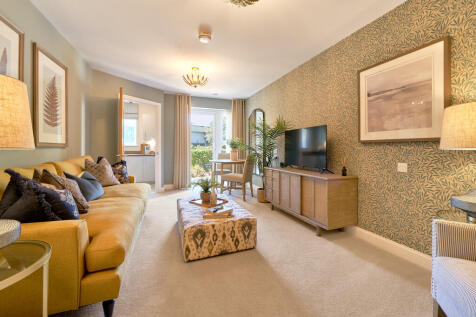 a living room with a large tv and couches