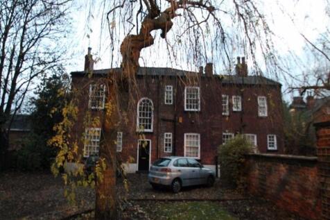 The exterior view of a charming brick house wit...