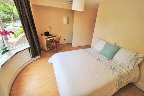 Bright master bedroom with a dedicated desk are...