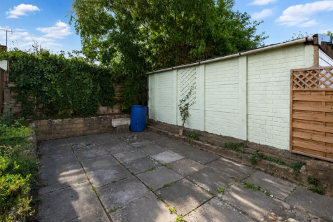 Sunny garden with soft blue skies.png