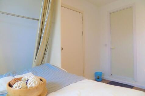 A simple and clean single bedroom with neutral ...