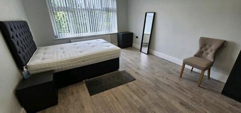 Spacious modern bedroom with bright window ligh...