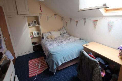 Cozy single bedroom with a neatly made bed, a s...