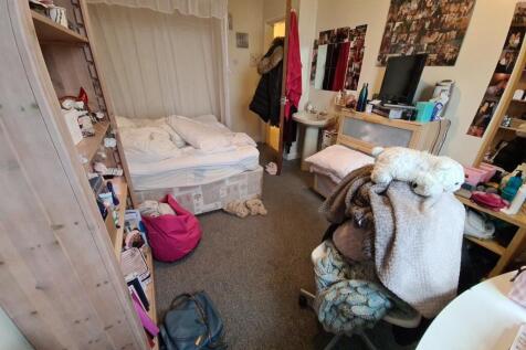 Cosy furnished bedroom with a double bed, ample...