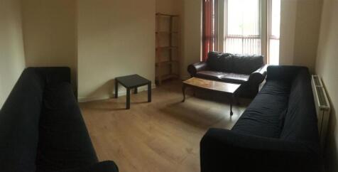 Bright, simply furnished living room with match...