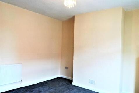 Bright, neutrally painted bedroom with fresh cr...