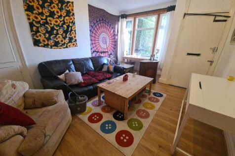 A cozy and well-lit living room featuring a com...