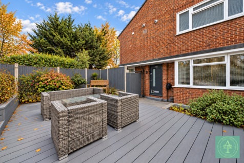 Modern Brick House Patio with Autumn Planting