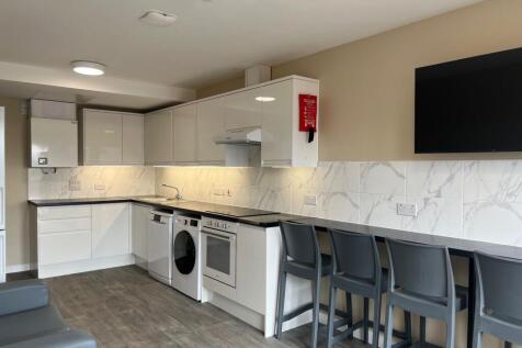 Modern shared kitchen with glossy white cabinet...