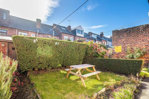 Sunny private garden with wooden picnic bench...