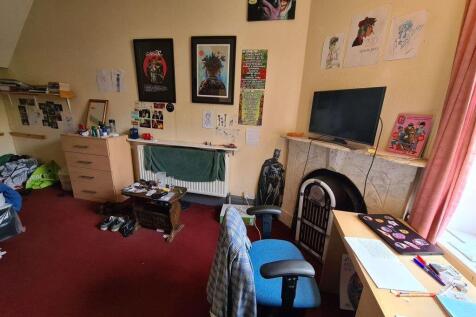 A comfortably spacious master bedroom featuring...